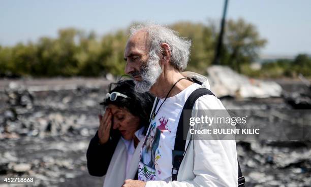 Angela Rudhart-Dyczynski and Jerzy Dyczynski from Australia react as they arrive on July 26, 2014 at the crash site of the Malaysia Airlines Flight...