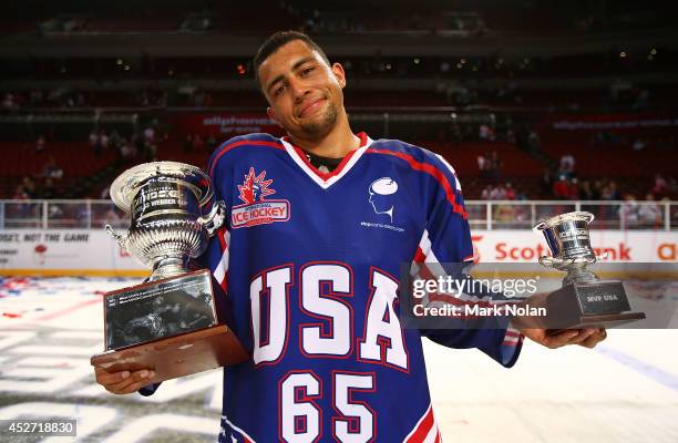 Emerson Etem of the USA poses with the Douglas Webber Cup and the MVP award for the USA after the USA won the International Ice Hockey Series between...