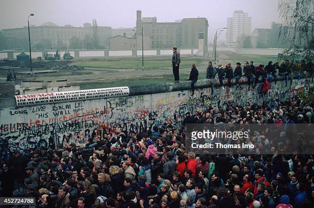 Mass of people in front of the Berlin Wall after opening of the border on November 09 in Berlin, Germany. The year 2014 marks the 25th anniversary of...