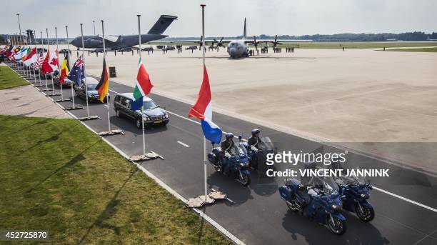 Hearses carrying the coffins with the remains of the victims of the Malaysian Airlines MH17 plane crash leave Eindhoven military airport on July 26,...