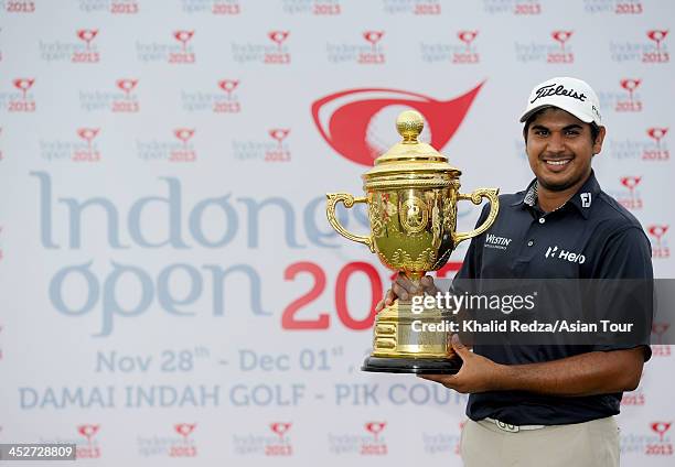 Gaganjeet Bhullar of India poses with the trophy after winning the US$750,000 Indonesia Open during round four of the Indonesia Open at Pantai Indah...