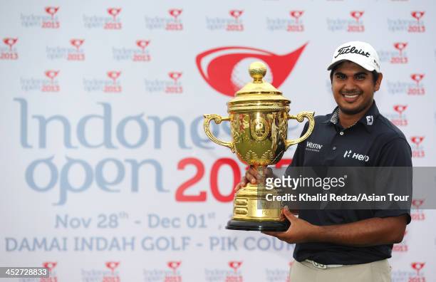 Gaganjeet Bhullar of India poses with the trophy after winning the US$750,000 Indonesia Open during round four of the Indonesia Open at Pantai Indah...