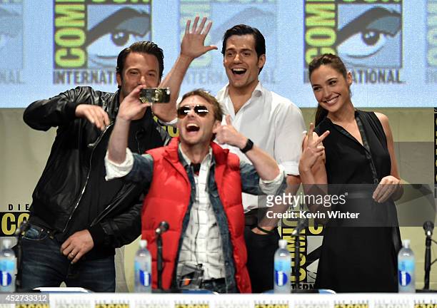 Moderator Chris Hardwick takes a selfie with actors Ben Affleck, Henry Cavill and Gal Gadot at the Warner Bros. Pictures panel and presentation...