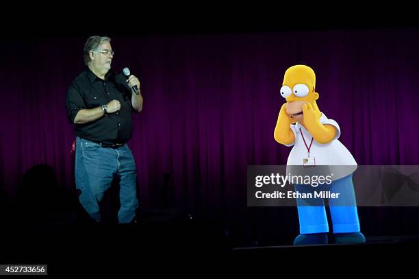 Writer/producer Matt Groening interacts with a projection of Homer Simpson during FOX's "The Simpsons" panel during Comic-Con International 2014 at...