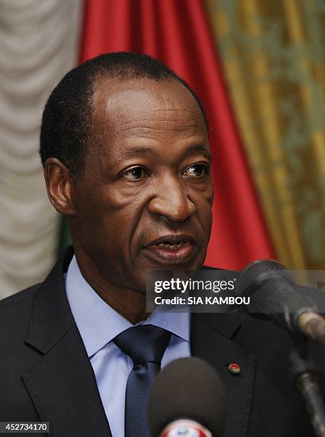 Burkina Faso's President Blaise Compaore speaks to relatives and acquaintances of the victims of the Air Algerie crash gathered at the Presidential...
