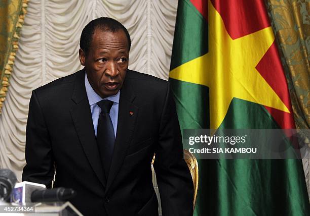 Burkina Faso's President Blaise Compaore looks on as he meets with relatives and acquaintances of the victims of the Air Algerie crash at the...