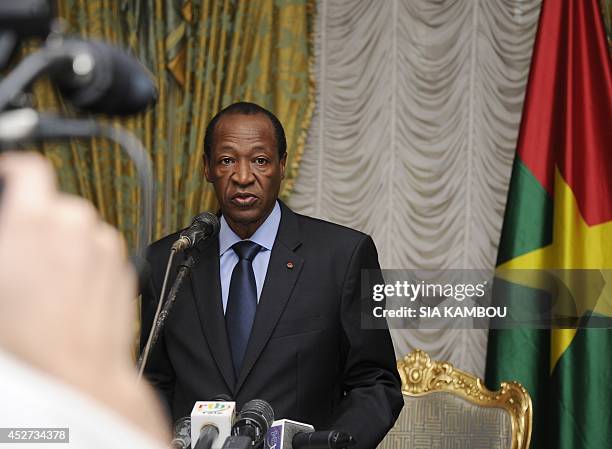 Burkina Faso's President Blaise Compaore speaks to relatives and acquaintances of the victims of the Air Algerie crash gathered at the Presidential...