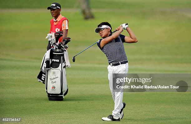 Nicholas Fung of Malaysia plays a shot during round four of the Indonesia Open at Pantai Indah Kapuk on December 1, 2013 in Jakarta, Indonesia.
