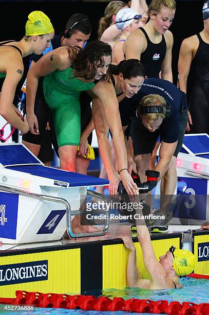 Bronte Barratt of Australia is congratulated by team mates Emma McKeon, Alicia Coutts and Brittany Elmslie of Australia after winning the gold medal...