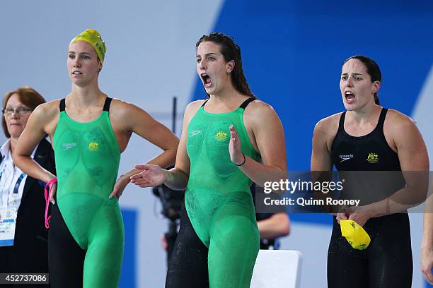 Emma McKeon, Brittany Elmslie and Alicia Coutts of Australia cheer on team mate Bronte Barratt of Australia on their way to winning the gold medal in...