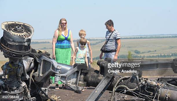 People visit the Malaysia Airlines flight MH17 crash site near the Grabovo town in Donetsk, Ukraine on July 26, 2014.