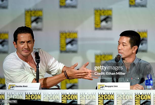 Actors Sasha Roiz and Reggie Lee attend the "Grimm" season four panel during Comic-Con International 2014 at the San Diego Convention Center on July...