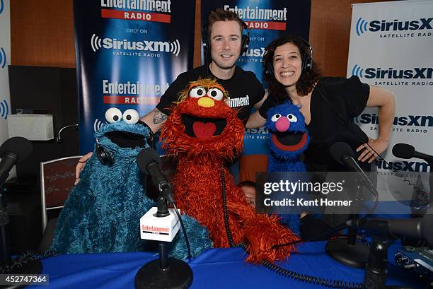 Muppet puppets Cookie Monster, Murray and Grover Grover pose with radio hosts Matt Bean and Jessica Shaw after being interviewed on SiriusXM's...