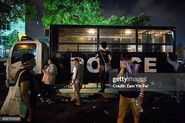 Anti-government protesters seize a police truck outside the government house on December 1, 2013 in Bangkok, Thailand. Anti-government protesters in...