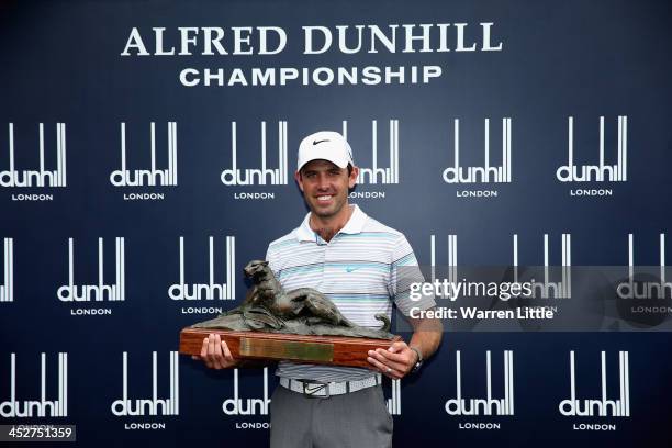 Charl Schwartzel of South Africa poses with the trophy after winning the Alfred Dunhill Championship on a score of -17 under par at Leopard Creek...