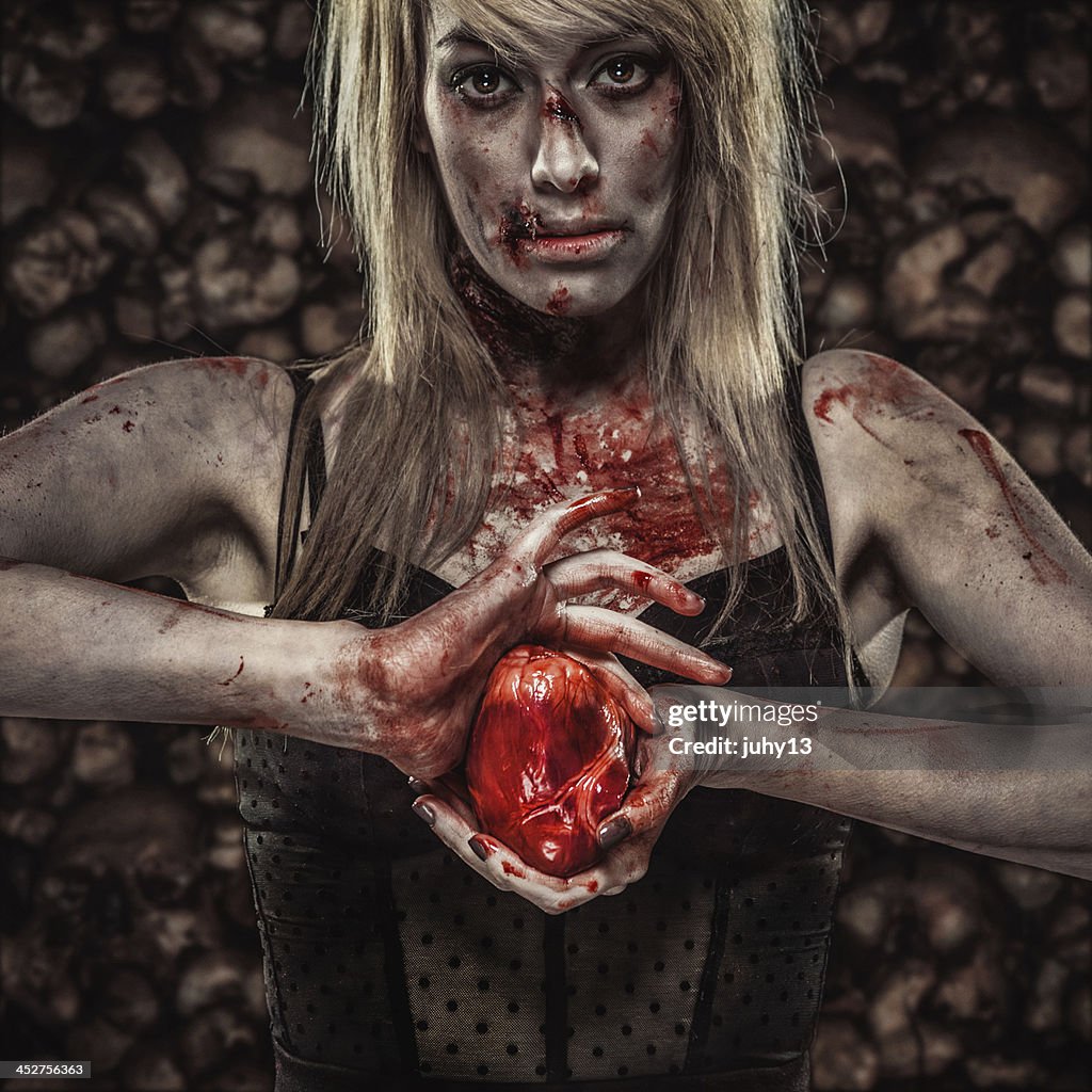 Young Zombie Woman Holding a Human Heart