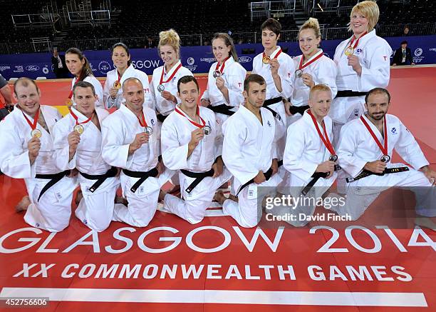 The successful Scottish Judo men and women's teams pose holding their medals on the last day of the judo competition at the Commonwealth Games Judo...