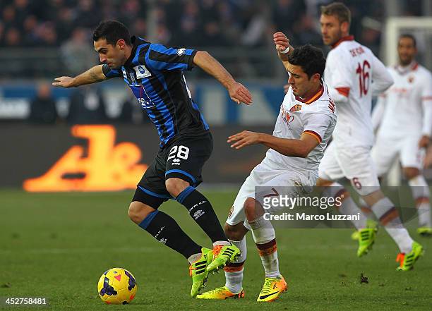 Davide Brivio of Atalanta BC competes for the ball with Marquinho of AS Roma during the Serie A match between Atalanta BC and AS Roma at Stadio...