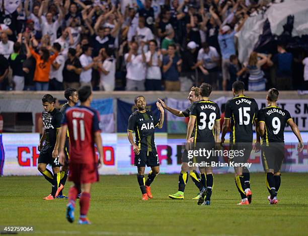 Aaron Lennon of Tottenham Hotspur is congratulated by his teammates after scoring a goal during the second half against the Chicago Fire at Toyota...