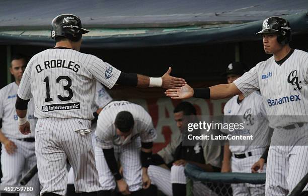 Oscar Robles celebrates with a teammate after scoring a run during a match between Tigres de Quintana Roo and Guerreros de Oaxaca as part of the...