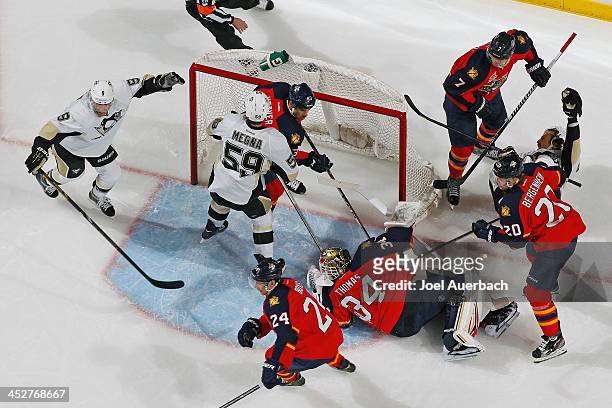 Goaltender Tim Thomas of the Florida Panthers lies on the ice after giving up a goal to Joe Vitale of the Pittsburgh Penguins at the BB&T Center on...