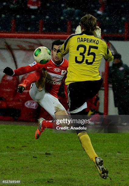 Hose Hurado of Spartak Moscow vies for the ball with goal keeper Sergey Pareyko during the Russian Premier League football match between Spartak...