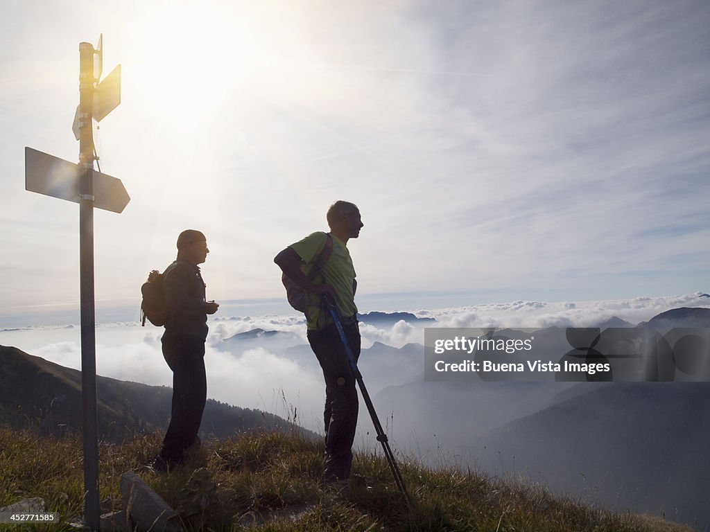 Two mature men trekking in mountains