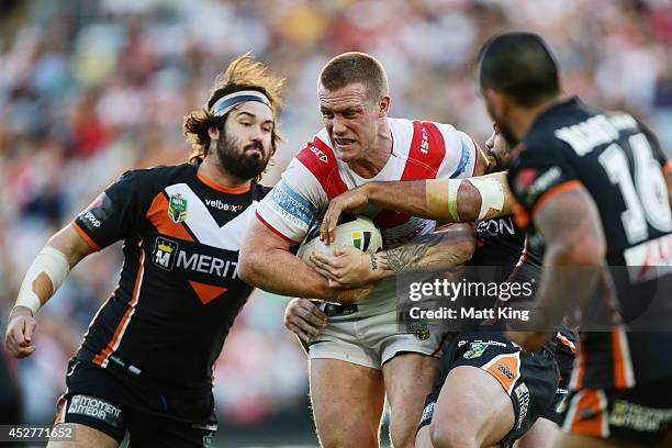Ben Creagh of the Dragons is tackled during the round 20 NRL match between the Wests Tigers and the St George Illawarra Dragons at ANZ Stadium on...