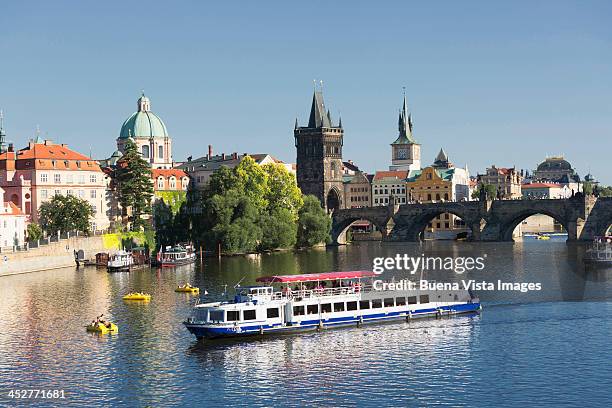 tourist boat and charles bridge on the moldau - the moldau river stock pictures, royalty-free photos & images
