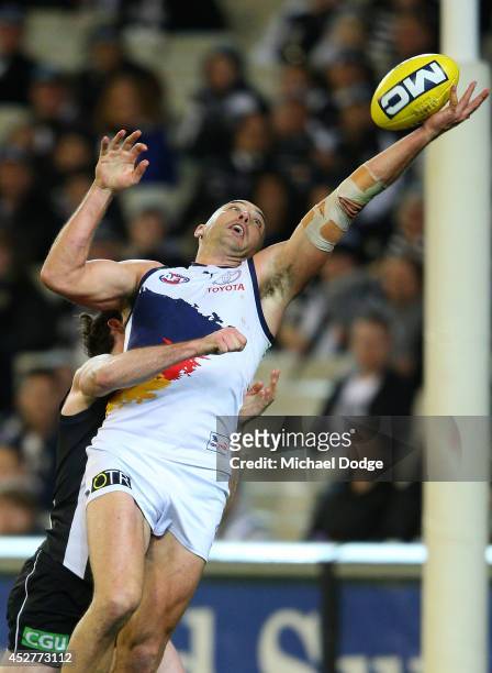 James Podsiadly of the Crows marks the ball one handed against Tyson Goldsack of the Magpies during the round 18 AFL match between the Collingwood...