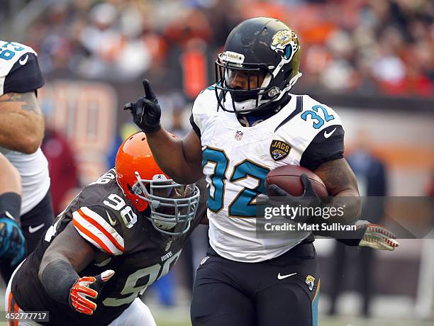 Running back Maurice Jones-Drew of the Jacksonville Jaguars runs the ball by defensive lineman Phil Taylor of the Cleveland Browns at FirstEnergy...