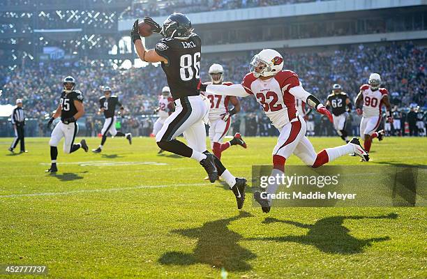 Zach Ertz of the Philadelphia Eagles catches a touchdown pass from Nick Foles as Tyrann Mathieu of the Arizona Cardinals prepares to tackle during...