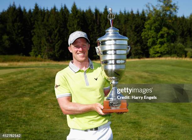 David Horsey of England celebrates with the trophy after winning the final round of the M2M Russian Open at Tseleevo Golf & Polo Club on July 27,...