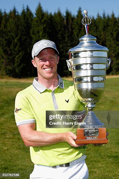 David Horsey of England celebrates with the trophy after winning the final round of the M2M Russian Open at Tseleevo Golf & Polo Club on July 27,...