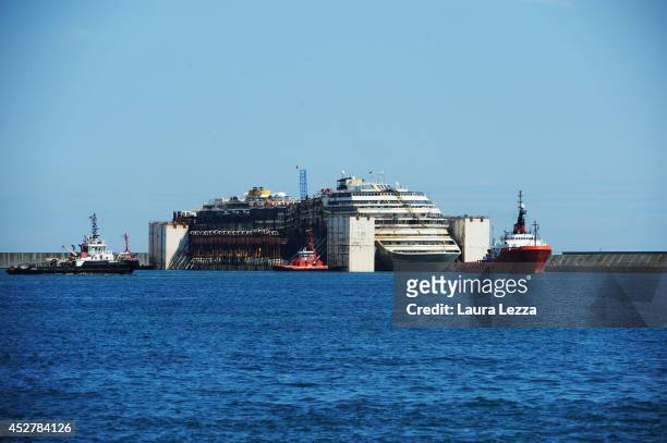 The Costa Concordia is seen inside the port of Pra-Voltri while tugs are completing the maneuvers on July 27, 2014 in Genoa, Italy. The Costa...