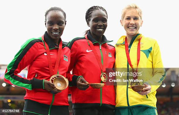 Silver medalist Caroline Kilel of Kenya, gold medalist Flomena Cheyech Daniel and bronze medalist Jess Tengrove of Australia stand on the podium...