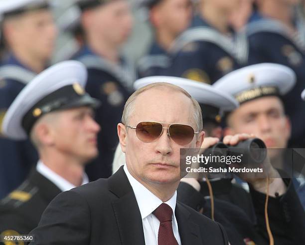 Russian President Vladimir Putin watches the Navy Day Military parade July 27, 2014 in Severomorsk. Putin is having a visit to Northern Fleet main...
