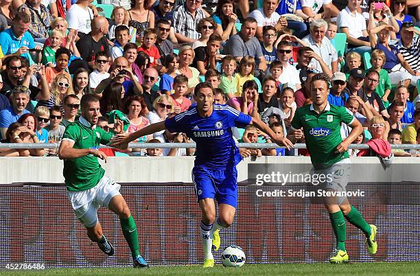 Nemanja Matic of Chelsea in action against Kenan Bajric and Antonio Mlinar Delamea of FC Olimpija Ljubljana during the Pre Season Friendly match...
