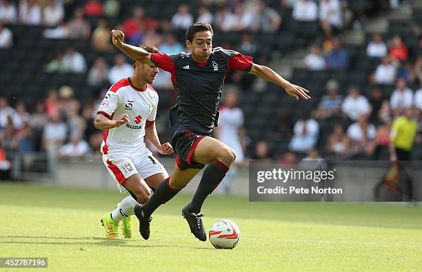 Tyler Walker of Nottingham Forest attempts to move forward with the ball away from George Baldock of MK Dons during the Pre-Season Friendly between...