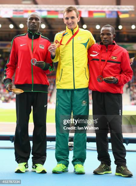 Silver medalist Stephen Chemlany of Kenya, gold medalist Michael Shelley of Australia and bronze medalist Abraham Kiplimo of Uganda stand on the...