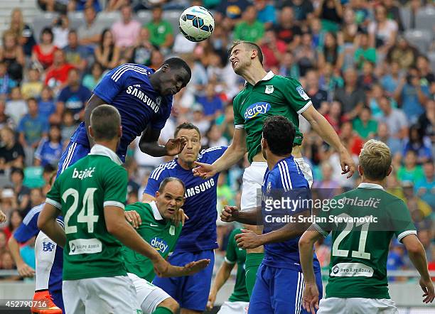 Kurt Zouma of Chelsea jump for the ball against Boban Jovic of FC Olimpija Ljubljana during the Pre Season Friendly match between FC Olimpija...