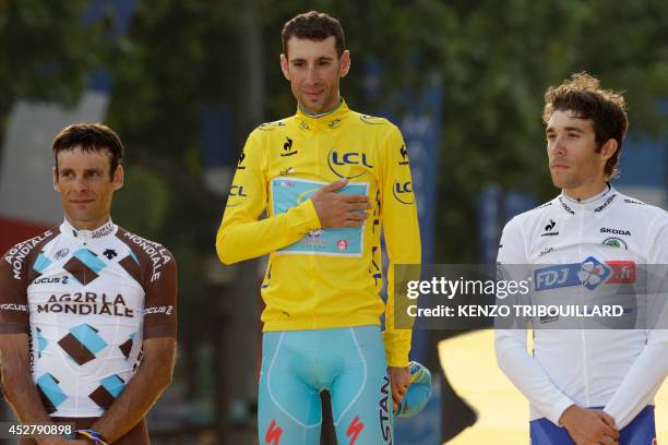 Tour de France 2014's winner Italy's Vincenzo Nibali , second-placed France's Jean-Christophe Peraud and third-placed France's Thibaut Pinot pose on...