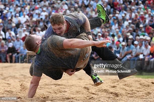 Swiss Alpine wrestler Joel Wicki fights on top with Marcel Kuster during the Alpine Wrestling Festival Bruenig-Schwinget at the top of the Bruenig...