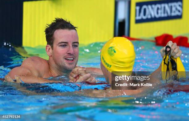 James Magnussen of Australia celebrates winning the gold medal in the Men's 100m Freestyle Final with silver medallist Cameron McEvoy of Australia at...