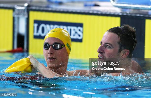 James Magnussen of Australia celebrates winning the gold medal in the Men's 100m Freestyle Final with silver medallist Cameron McEvoy of Australia at...