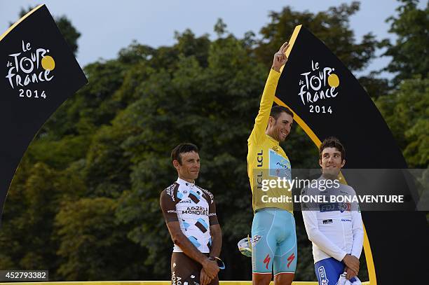 Tour de France 2014's winner Italy's Vincenzo Nibali , second-placed France's Jean-Christophe Peraud and third-placed France's Thibaut Pinot pose on...