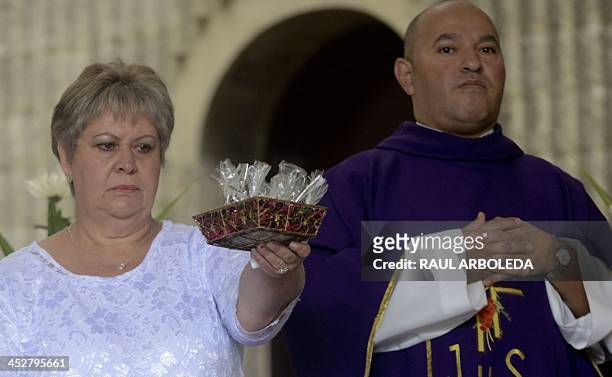 Colombian drug lord Pablo Escobar's sister, Luz Maria Escobar , takes part in a mass at Montesacro cemetery in Medellin, Antioquia department,...