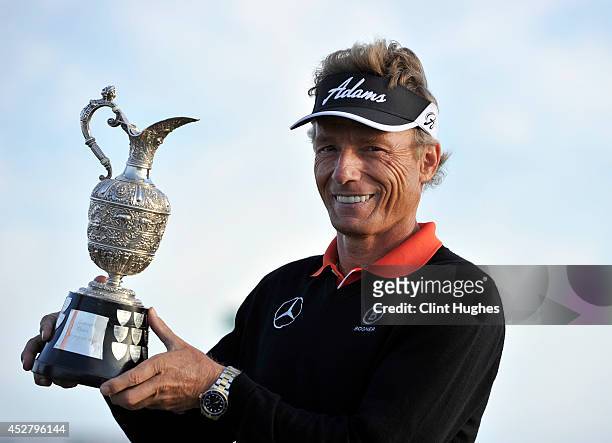 Bernhard Langer of Germany holds the Senior Open Championship trophy after his victory during the fourth round of the Senior Open Championship at...