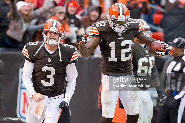 Quarterback Brandon Weeden and wide receiver Josh Gordon of the Cleveland Browns celebrate after Gordon scored a touchdown on a pass from Weeden...
