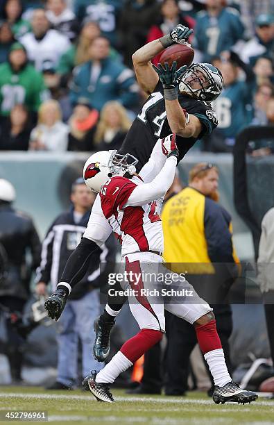 Wide receiver Riley Cooper of the Philadelphia Eagles can't control possession of the ball after being hit by cornerback Jerraud Powers of the...